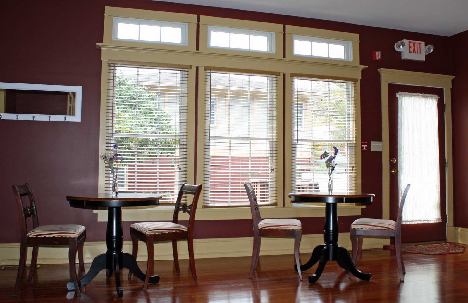 Rear of dining room with two small tables for two